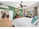 Bright bedroom featuring a ceiling fan, hardwood floors, and ensuite access to the lanai at 4769 Stoneview Cir, Oldsmar, FL 34677