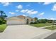 This single-story home features an expansive driveway and well-maintained landscaping at 4769 Stoneview Cir, Oldsmar, FL 34677