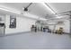 Spacious two-car garage with painted floor and shelving for organized storage at 4769 Stoneview Cir, Oldsmar, FL 34677