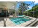 Elevated hot tub adjacent to a refreshing pool, all within a screened-in lanai at 4769 Stoneview Cir, Oldsmar, FL 34677