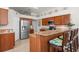 Kitchen area with stainless steel appliances and wooden cabinetry at 4769 Stoneview Cir, Oldsmar, FL 34677