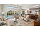 Open living area with a pool view, comfortable seating, and natural light at 4769 Stoneview Cir, Oldsmar, FL 34677