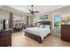 Bedroom with hardwood floors, ceiling fan, and view of the outdoor area at 4769 Stoneview Cir, Oldsmar, FL 34677