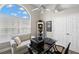 This well-lit home office features comfortable seating and generous natural light at 4769 Stoneview Cir, Oldsmar, FL 34677
