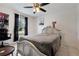 Bedroom with a silver bed frame, ceiling fan, and view to outside at 4816 E 99Th Ave, Tampa, FL 33617