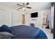 Bedroom featuring ensuite bathroom, walk-in closet, ceiling fan, and mounted TV at 4816 E 99Th Ave, Tampa, FL 33617