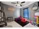 Playful bedroom featuring a red Spiderman-themed bed, a cozy beanbag chair, and gray walls at 4816 E 99Th Ave, Tampa, FL 33617