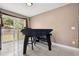Open dining area featuring sliding glass doors to the outside and sleek tile flooring at 4816 E 99Th Ave, Tampa, FL 33617