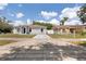 Inviting single-story home with a gray exterior, complemented by a spacious driveway at 4816 E 99Th Ave, Tampa, FL 33617