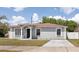 Charming single-story home with light gray exterior paint and a well-manicured lawn at 4816 E 99Th Ave, Tampa, FL 33617