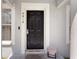 Close-up of the front door with sidelights, displaying the house number and a cozy front porch at 4816 E 99Th Ave, Tampa, FL 33617
