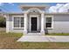 Inviting home entrance with classic black door and detailed trim at 4816 E 99Th Ave, Tampa, FL 33617