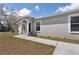 Charming single-story home with arched doorway and a well-maintained front yard at 4816 E 99Th Ave, Tampa, FL 33617