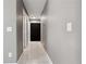 Neutral painted hallway with tile floors, white doors and utility access panel at 4816 E 99Th Ave, Tampa, FL 33617
