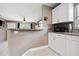 Efficient kitchen with white cabinetry and an open view into the living area at 4816 E 99Th Ave, Tampa, FL 33617