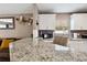 Kitchen counter with granite countertops, neutral paint, microwave and white cabinets at 4816 E 99Th Ave, Tampa, FL 33617