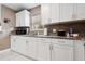 Kitchen with granite countertops, stylish backsplash, and white cabinets at 4816 E 99Th Ave, Tampa, FL 33617