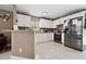 Modern kitchen featuring white cabinets, stainless steel appliances, and granite countertops at 4816 E 99Th Ave, Tampa, FL 33617