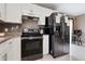 Modern kitchen features stainless steel appliances, granite countertops and sleek cabinetry at 4816 E 99Th Ave, Tampa, FL 33617