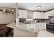 Kitchen featuring granite countertops, white cabinets, stainless steel appliances, and tile flooring at 4816 E 99Th Ave, Tampa, FL 33617