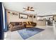Open-concept living room with tile floors, ceiling fan, and comfortable seating at 4816 E 99Th Ave, Tampa, FL 33617