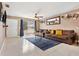 Bright living room with tile flooring, comfortable seating, decor, and natural light from a window at 4816 E 99Th Ave, Tampa, FL 33617