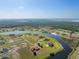 An aerial view of a community with waterfront homes, beautiful green land and trees at 5325 San Remo Cir, Wimauma, FL 33598