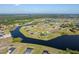 Aerial view of the community showcasing lakefront homes, and lush greenery at 5325 San Remo Cir, Wimauma, FL 33598