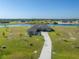 Beautiful single-Gathering home with lush landscaping, lake views, and a long driveway at 5325 San Remo Cir, Wimauma, FL 33598