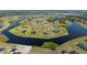 Aerial view of a lake community, with water views and lush lawns at 5325 San Remo Cir, Wimauma, FL 33598