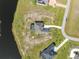 An aerial view of home featuring a pool with a spacious yard near the water and a long driveway at 5325 San Remo Cir, Wimauma, FL 33598