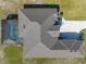 Drone shot of the home featuring a backyard screened pool, driveway, and lush landscaping at 5325 San Remo Cir, Wimauma, FL 33598