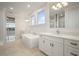Modern bathroom with soaking tub, double vanity, large mirror, and a separate glass shower at 5325 San Remo Cir, Wimauma, FL 33598