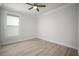 This cozy bedroom is bright, with a ceiling fan and beautiful wood-look flooring at 5325 San Remo Cir, Wimauma, FL 33598