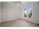 Bedroom with natural light, ceiling fan, beautiful floors, and charming arched windows at 5325 San Remo Cir, Wimauma, FL 33598