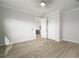Bedroom with light hardwood floors and open doorway at 5325 San Remo Cir, Wimauma, FL 33598
