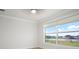 Bright bedroom with a ceiling fan and a large window offering views of a lake at 5325 San Remo Cir, Wimauma, FL 33598