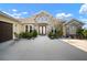 Inviting home with stone facade, manicured landscaping, and a front entrance with double doors at 5325 San Remo Cir, Wimauma, FL 33598