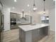 Modern kitchen with stainless steel appliances, white countertops, tile backsplash, and gray cabinets at 5325 San Remo Cir, Wimauma, FL 33598