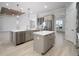 Modern kitchen with gray cabinets, center island with a sink and stainless steel appliances at 5325 San Remo Cir, Wimauma, FL 33598
