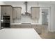 This kitchen features gray cabinets, stainless appliances, tile backsplash and white quartz countertops at 5325 San Remo Cir, Wimauma, FL 33598