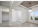 Spacious living room with neutral walls, hardwood floors, a chandelier, and natural light at 5325 San Remo Cir, Wimauma, FL 33598