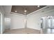 Large open space with hardwood floors, a tray ceiling, and bright, white-painted walls at 5325 San Remo Cir, Wimauma, FL 33598