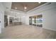 Open living room and kitchen area with lots of natural light and wood-look tile flooring at 5325 San Remo Cir, Wimauma, FL 33598