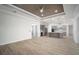 Open living room leading into the kitchen area with gray cabinets and stainless steel appliances at 5325 San Remo Cir, Wimauma, FL 33598