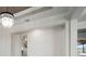 Bright, open-concept space, with hard wood floors, leading to a kitchen and an outdoor patio with a view at 5325 San Remo Cir, Wimauma, FL 33598