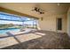 A screened-in patio overlooks a pristine pool, gorgeous lake, and lush greenery at 5325 San Remo Cir, Wimauma, FL 33598