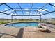 Lovely screened pool area with water features and brick pavers, with a beautiful lake view at 5325 San Remo Cir, Wimauma, FL 33598