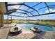 Inviting screened pool with brick pavers and view of the beautiful lake at 5325 San Remo Cir, Wimauma, FL 33598