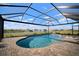 Screened pool and spa with brick pavers, perfect for relaxing by the lake at 5325 San Remo Cir, Wimauma, FL 33598
